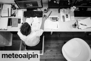 Black and Gray Photo of Person in Front of Computer Monitor