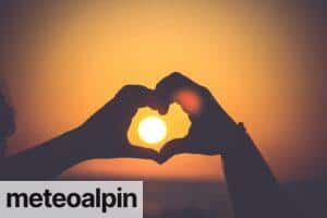 silhouette of person's hands forming heart
