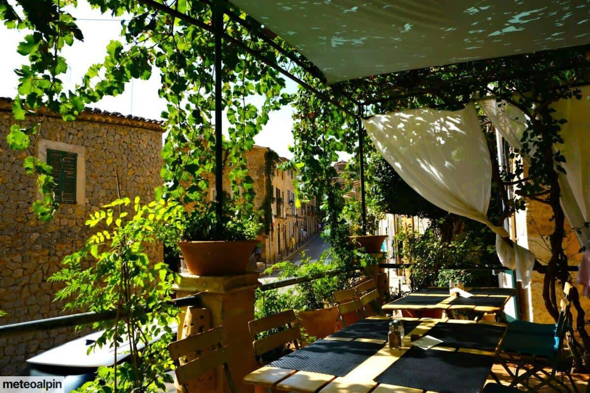 a patio with tables and chairs